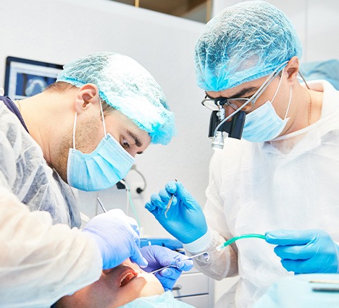 Dental team carefully working to place dental implants