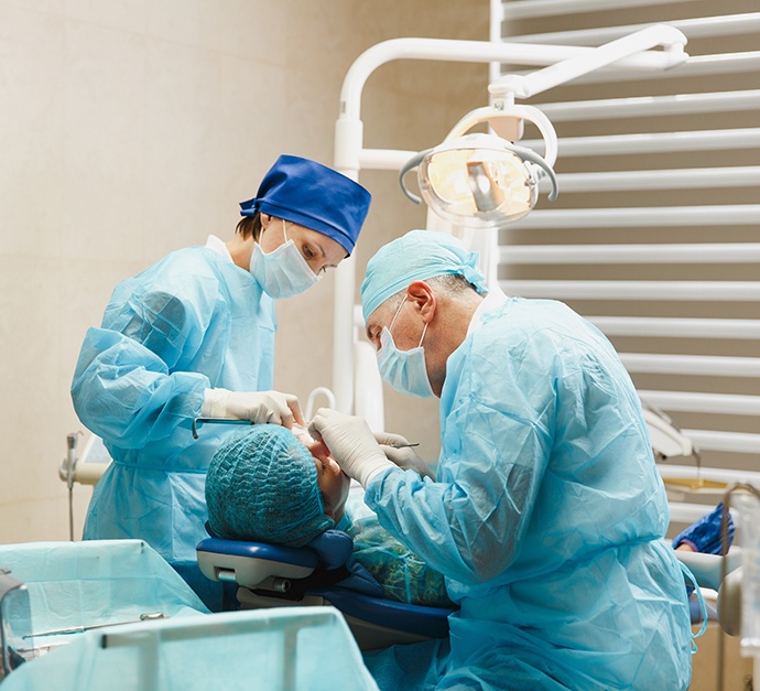 Dental surgery team carefully working on patient