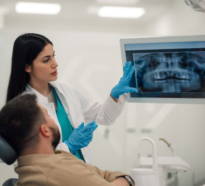 Patient and dentist reviewing X-rays