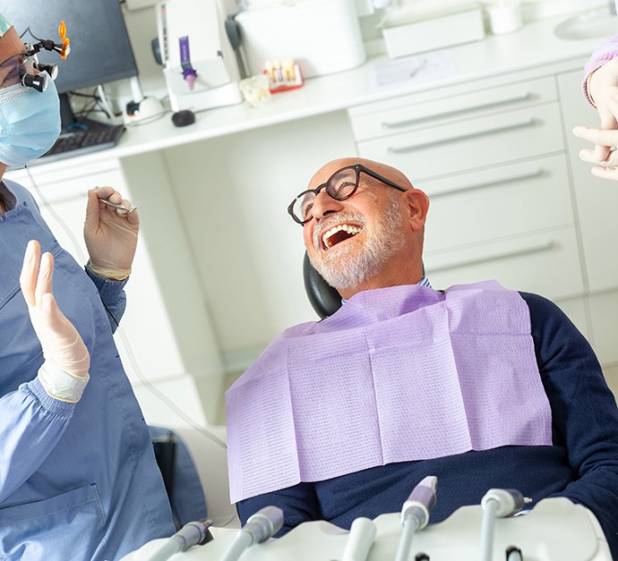 Patient laughing with his dental team