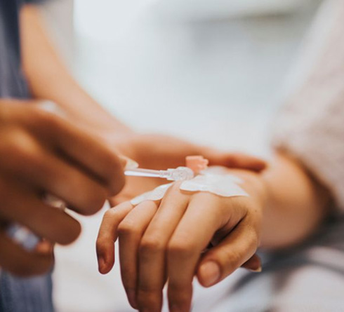 Person getting IV placed in her hand