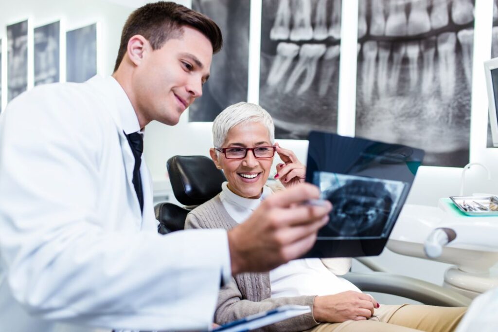 A woman reviewing an X-ray with her dentist