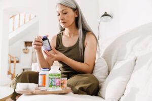 Woman looking at her supplements and medications 